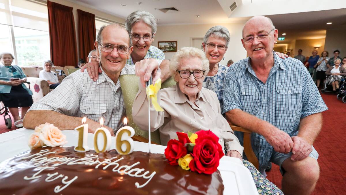 Make a wish: Ivy Martin cuts her cake as eldest son Richard, daughters-in-law Anne and Jackie and youngest son Philip watch on.