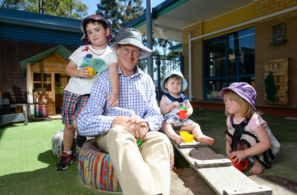 Building blocks: Michael Traill at the Goodstart centre in West Albury with Archer Wilson, 4, Shelbie Ritchie, 15 months, and Scarlett Ritchie, 3. He helped transform the operation as part of his work in social enterprise. Picture: MARK JESSER 