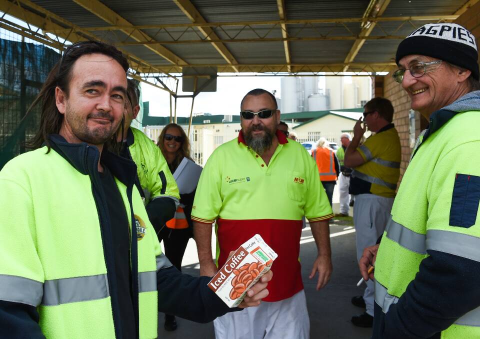 All done: Kevin Witt savours one of the last cartons of Kiewa iced coffee as Andrew 'Snags' Cameron and his father Jim Witt look on following the end of milk production at the plant. Picture: MARK JESSER