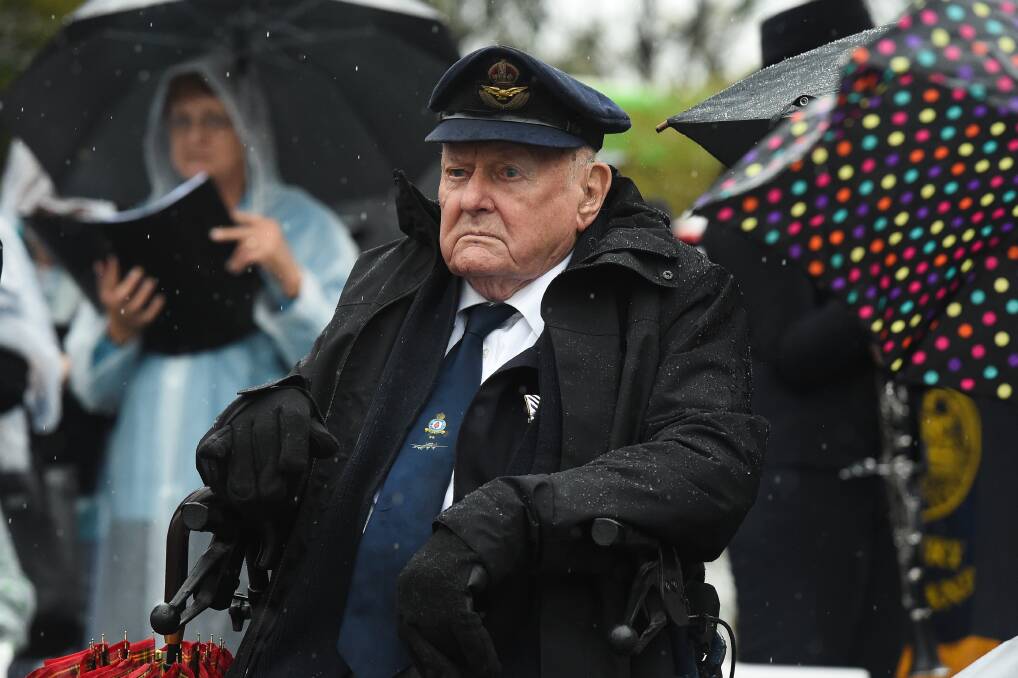 Still soaring: Former bomber command squadron leader Edgar Pickles, 96, watches the Albury Anzac Day service with his original Royal Air Force cap bought from a London tailor more than 70 years ago. Pictures: MARK JESSER