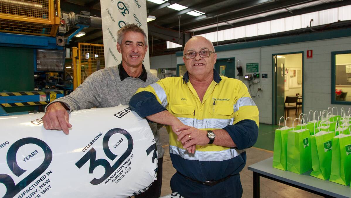 Celebrating: Geofabrics general manager manufacturing Howard Yen and factory veteran Neville Quast mark their workplace's 30th anniversary. Picture: SIMON BAYLISS
