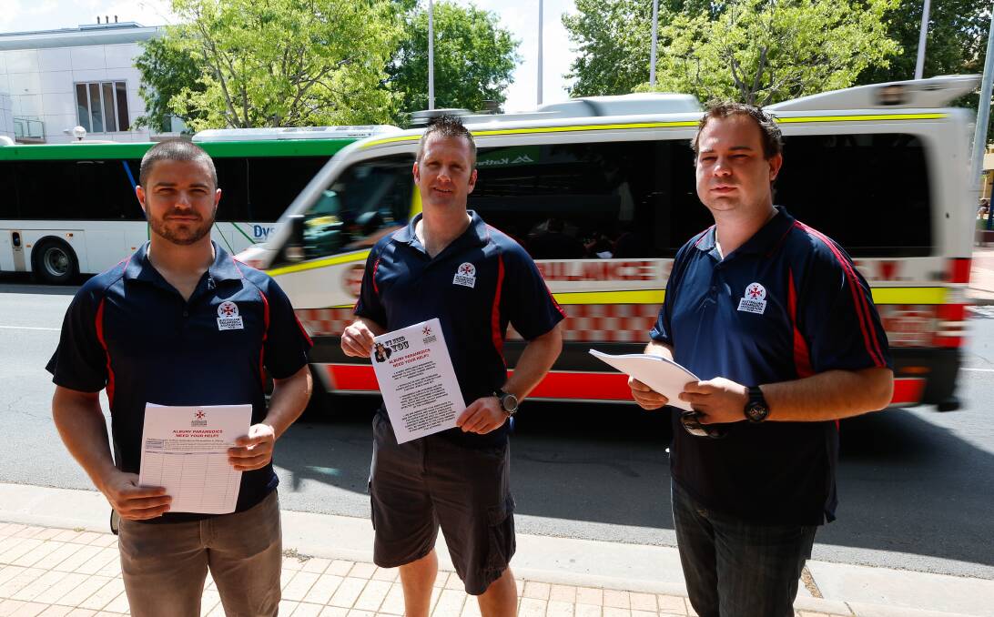 Hitting the streets: Albury paramedics Luke Allsop, John McCormack and Ned Gavranic with petitions and flyers that will be distributed in the central business district on Wednesday. Picture: MARK JESSER