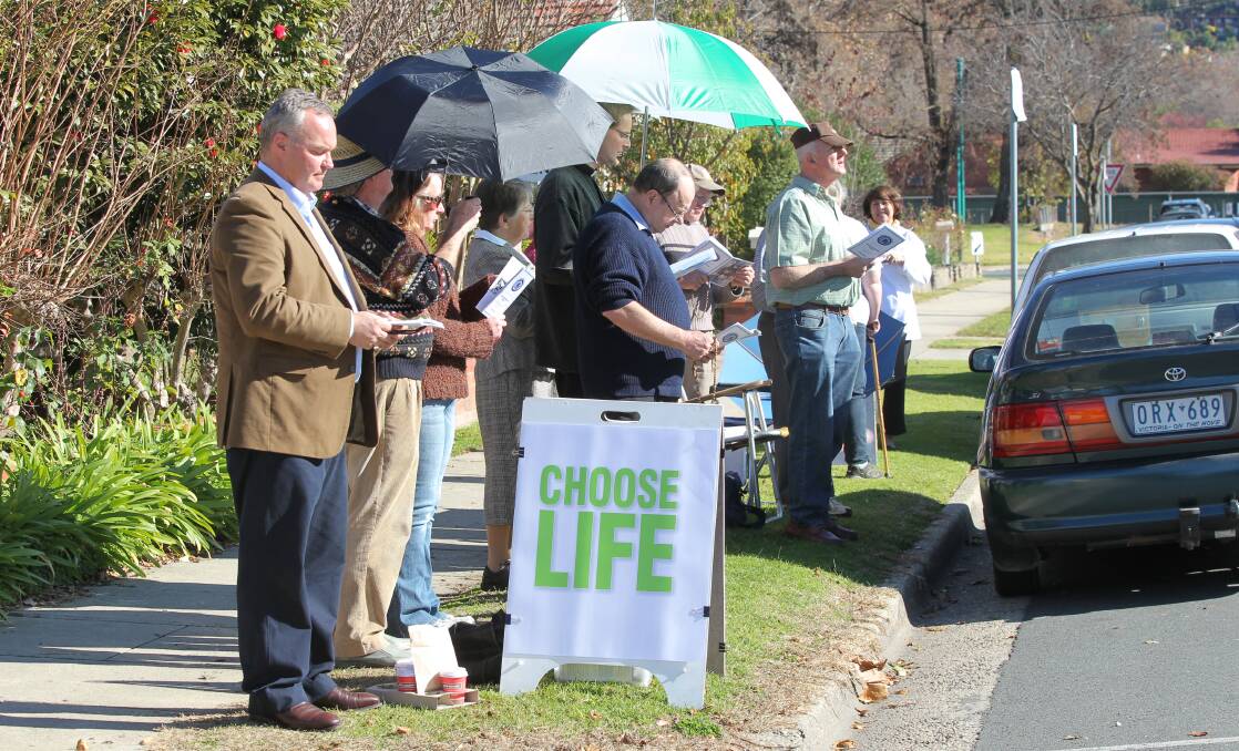 Lined up: Roland von Marburg (closest to camera) joins other anti-abortion activists across the road from the Englehardt Street clinic during a Thursday vigil.