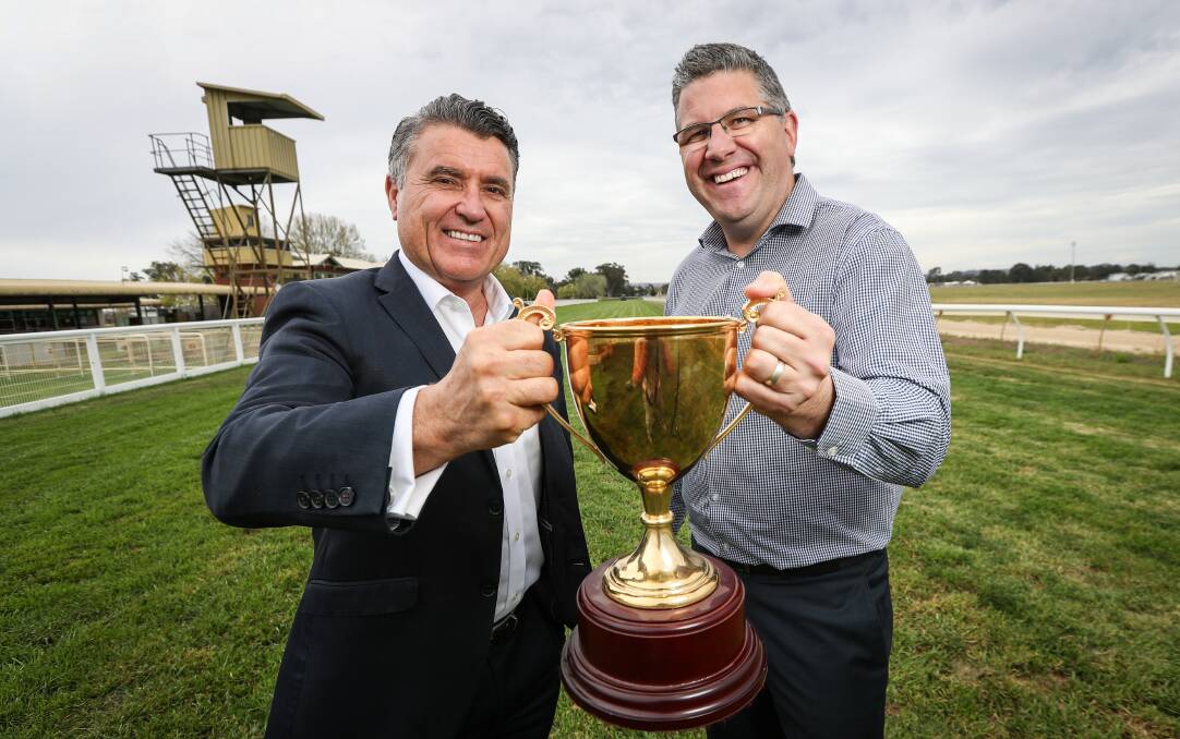 Ready to race: McRae Motors dealer principal Mick Blomeley and Racing Wodonga general manager Tom O'Connor with the gold cup which will be presented on Friday.