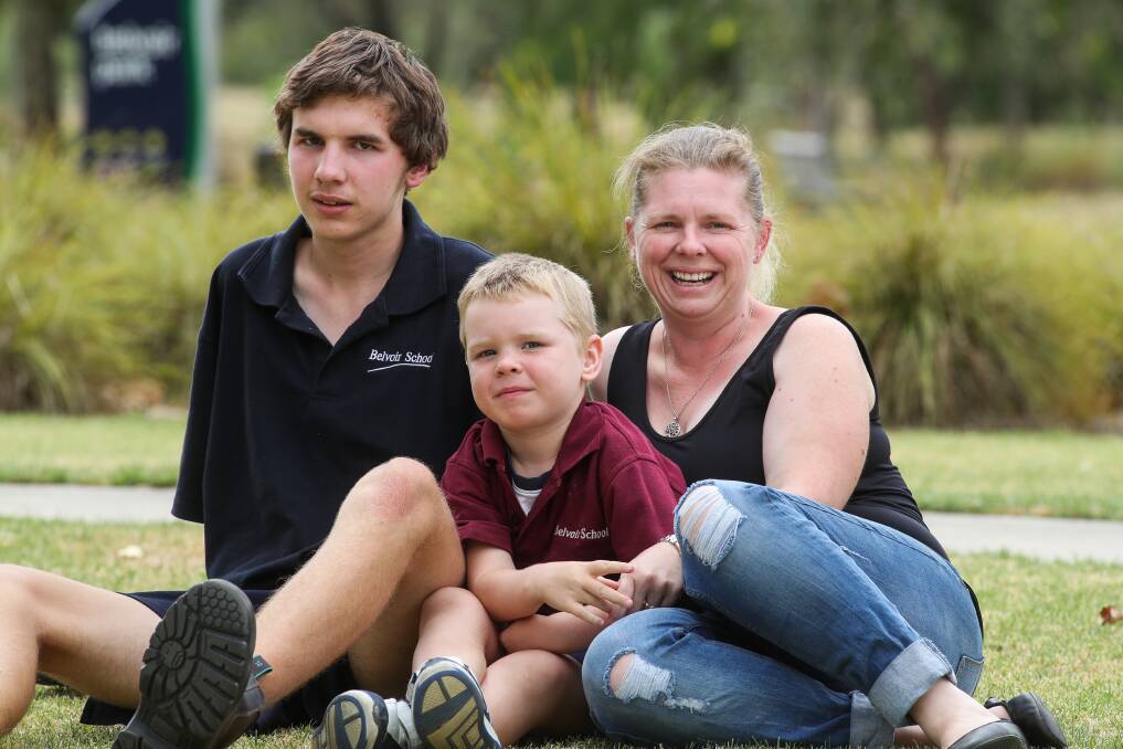 Uncertain outlook: Tenniell Evans with her sons Liam, 15, and Luke, 6, who have autism and will benefit from the NDIS, previously administered by Indigo Shire's home and community care program. Picture: MARK JESSER 