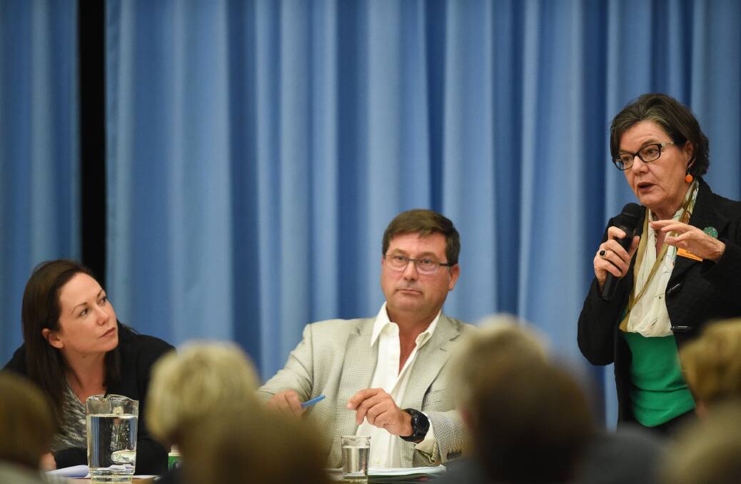 Political views: Labor MLC Jaclyn Symes and Liberal member for Benambra Bill Tilley listen to the independent member for Indi Cathy McGowan at a public meeting at Tangambalanga to discuss fallout from Murray Goulburn's factory closure. Picture: MARK JESSER