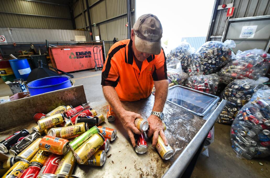Mountains of cans: Corowa's D & M Scrap Metal has experienced a flood of containers through being a collection point for the Return and Earn scheme and has employed extra staff to cope.