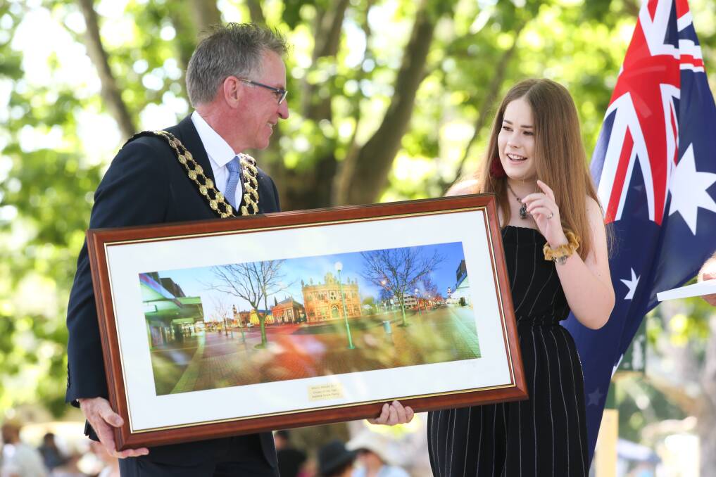 Congratulations: Mayor Kevin Mack presents a framed photograph of Albury's Dean Street to young citizen of the year Isabella Percy. Picture: KYLIE ESLER 