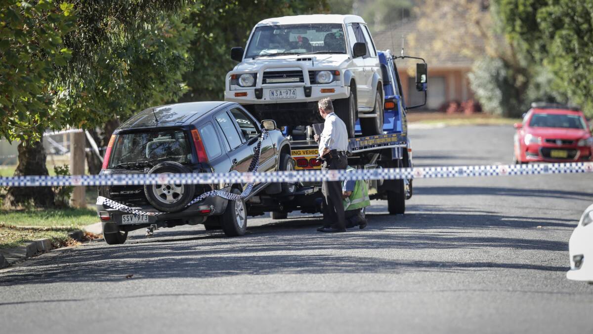 Crime scene: Vehicles are removed from Corowa's Vera Street following the death of Christopher Quirk on Saturday.