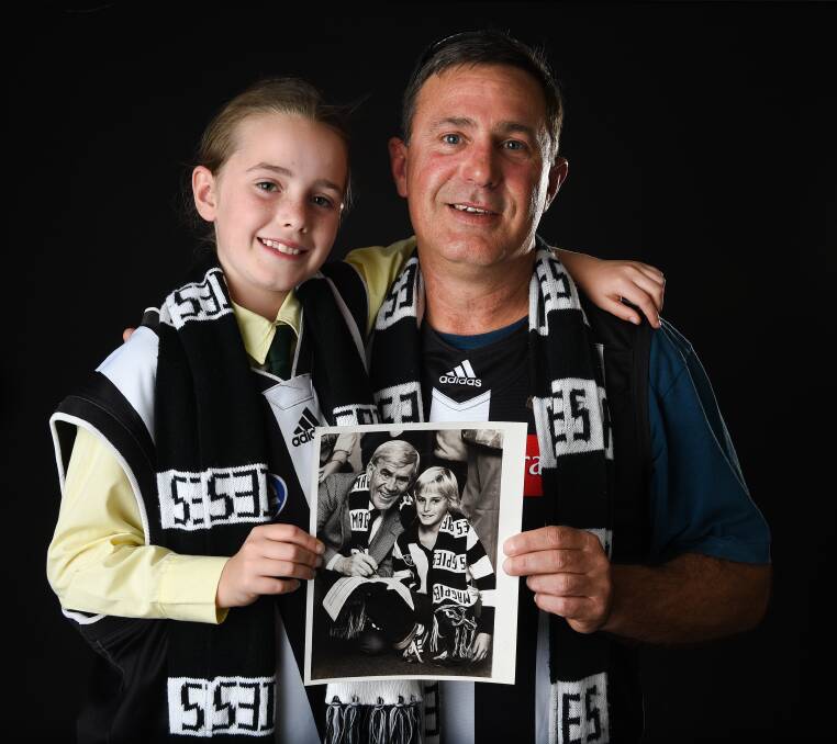 Through the generations: Jeff Morgan with his daughter Abby, 9, and the original photograph that appeared in The Border Mail when Lou Richards came to Lavington in 1983.