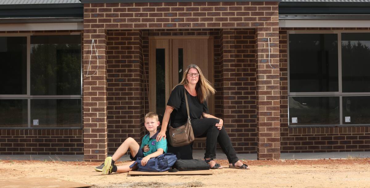 Heartbreak: Robyn King and her son Mitchell outside their new home at Osbornes Flat which cannot be connected to the power grid because of an industrial dispute. Picture: KYLIE ESLER