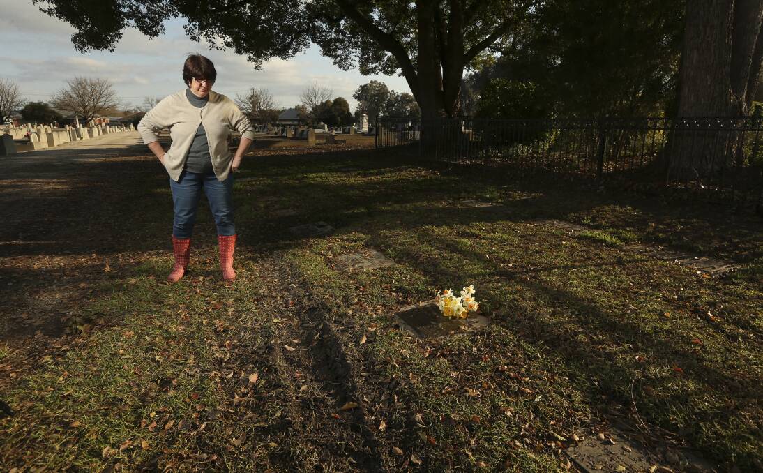 Painful tracks: Denise Stewart looks over tyre marks left over grave sites at the Waugh Road cemetery.
