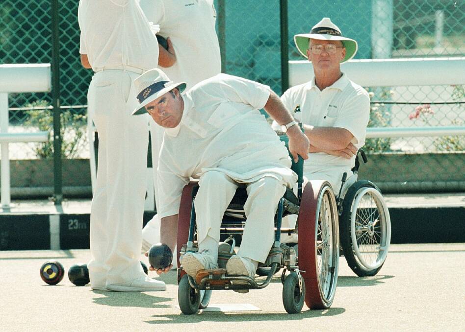In action: Stan Sims delivers a bowl during a tournament at the Albury SS and A Club rink in April 1999. His wheelchair was special modified so its tyres did not damage the grass.