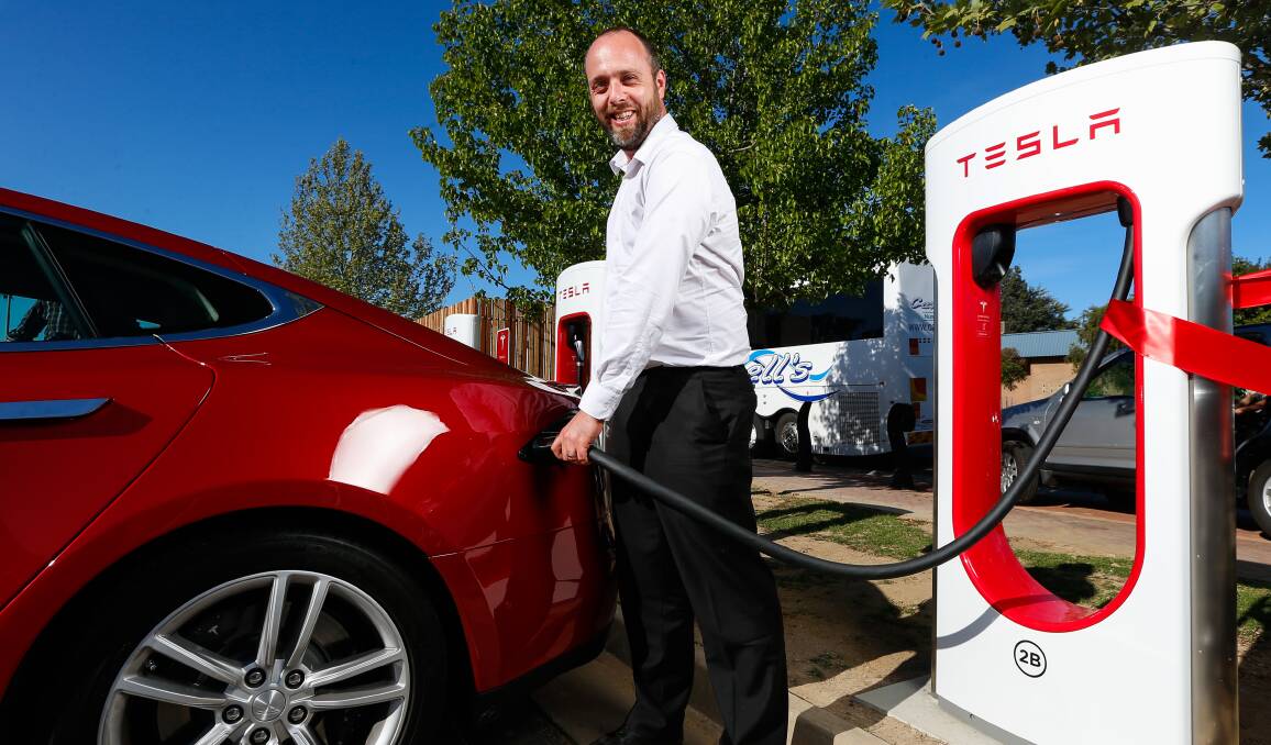 Powering up: Tesla manager Evan Beaver uses the new charging station which was officially opened in Wodonga on Thursday afternoon. Picture: MARK JESSER 