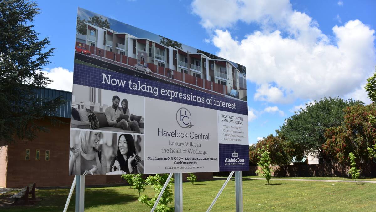 Sign of the times: A billboard outside St John's promotes the Havelock Central housing development which will bankroll a new church. 