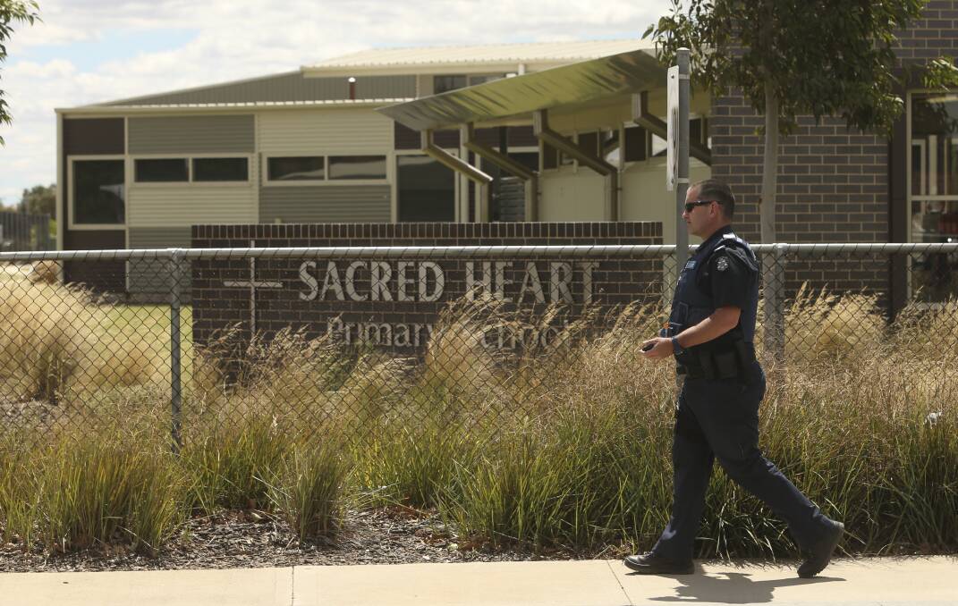 On the list: Cobram policeman Damian Loiterton at Yarrawonga's Sacred Heart Primary School which was the target of a bomb hoax in February last year.