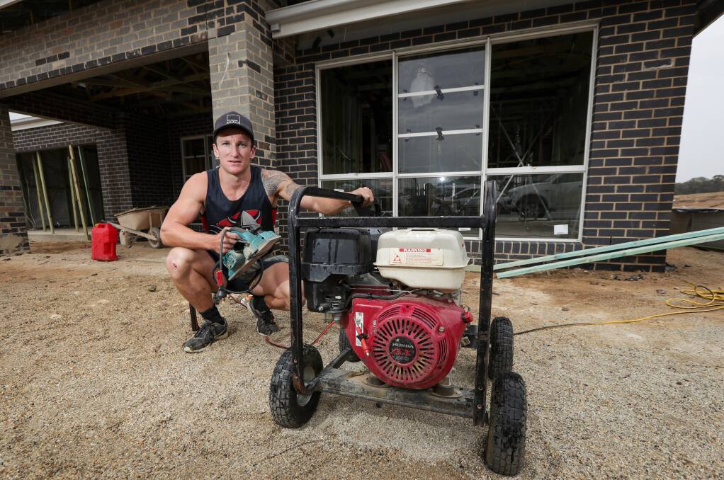 Power down: Carpenter Ben Murphy has had to use generators on building sites due to a dispute stopping electricity connections to new homes. Picture: JAMES WILTSHIRE