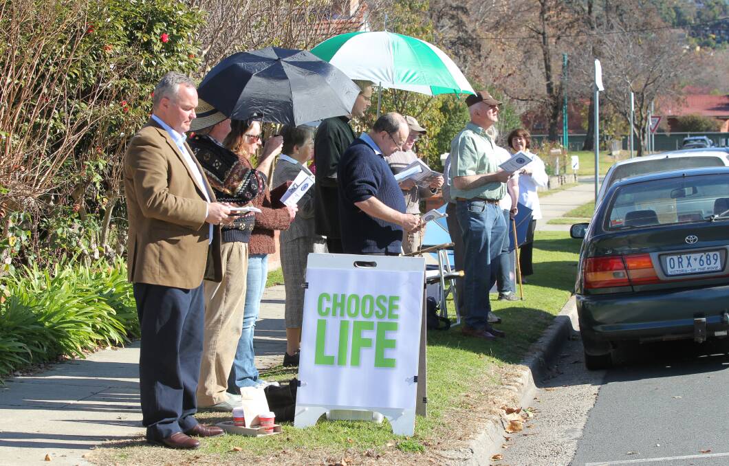 Standing firm: Roland von Marburg (far left) with other pro-life campaigners across the road from Albury's Englehardt Street abortion clinic.
