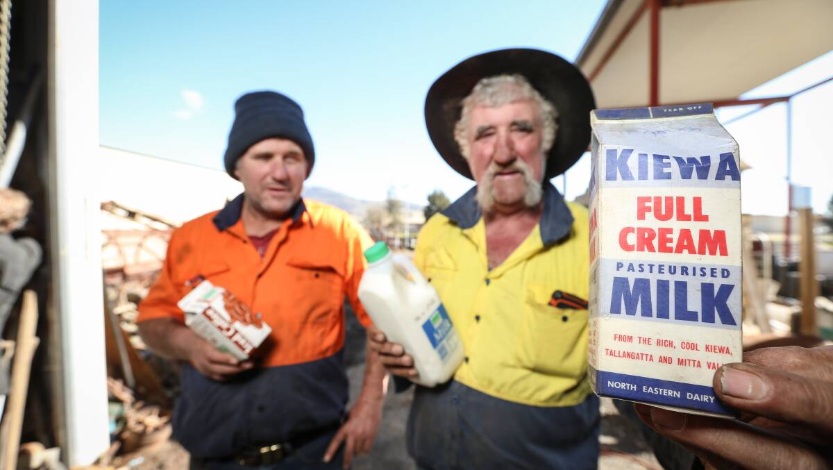 Going into history: Mark and Jack Britton with some of the last Kiewa milk and an old pint carton which was unused because it had an imperial measurement instead of a metric volume. Picture: JAMES WILTSHIRE