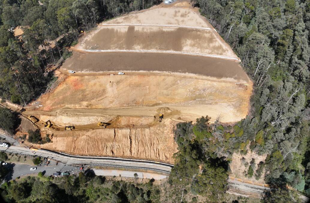 Trucks and workers in operation in recent weeks along a section of the Bogong High Plains Road affected by the October 2022 landslide. Picture from Major Road Projects Victoria 
