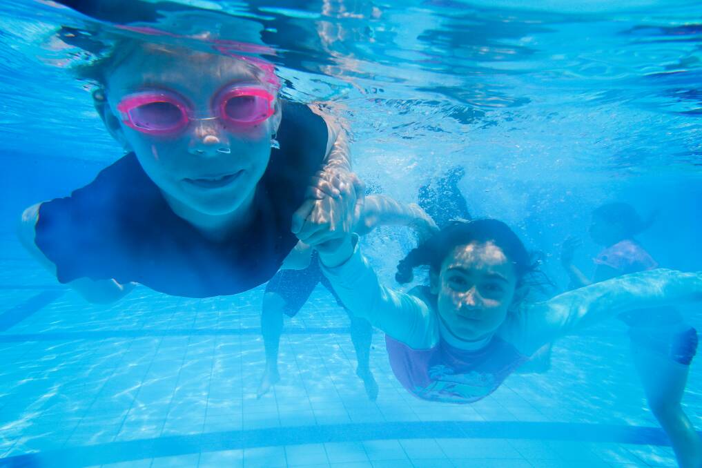 In the swim: Children play in the WAVES pool which has had problems with tiles becoming loose resulting in plans to replace them at the end of this swimming season.