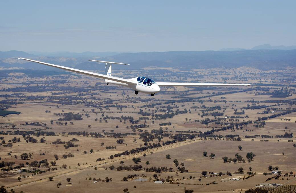 Turbulent times: A glider soars over Benalla. The town's airfield has housed Victoria's Gliding Club since 1952 but a rental wrangle could see it relocate.