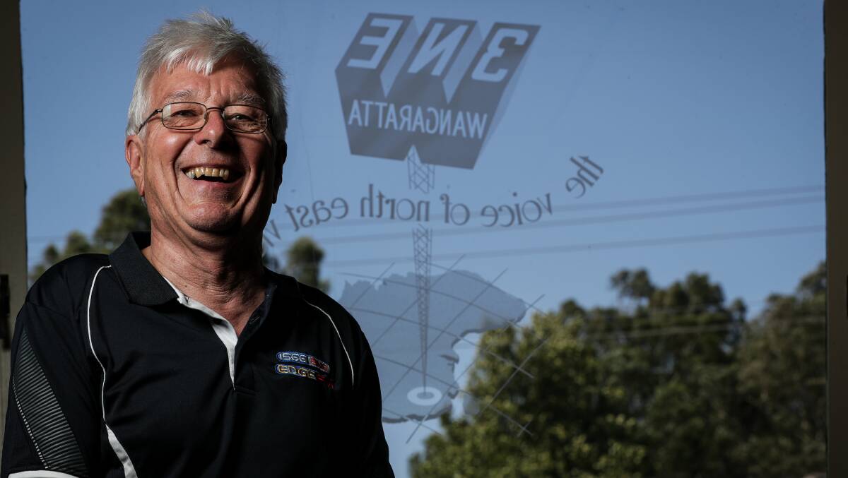 The retiring type: Paul Konik before the window at the front of the 3NE studios in Wangaratta. The original logo of the station is featured on the glass. Picture: JAMES WILTSHIRE