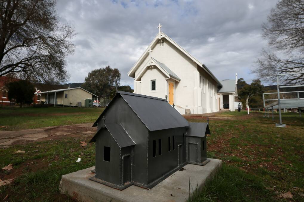 Big and small: A miniature replica of the Eskdale church has been built to cover the water meter in front of the 1929 building.