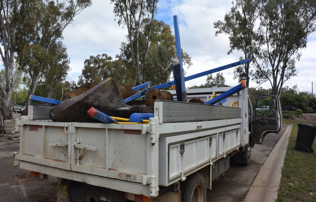 Fun's over: Playground equipment is removed from Corowa's Bangerang Park after being deemed unsafe due to the inundation from the Murray River.