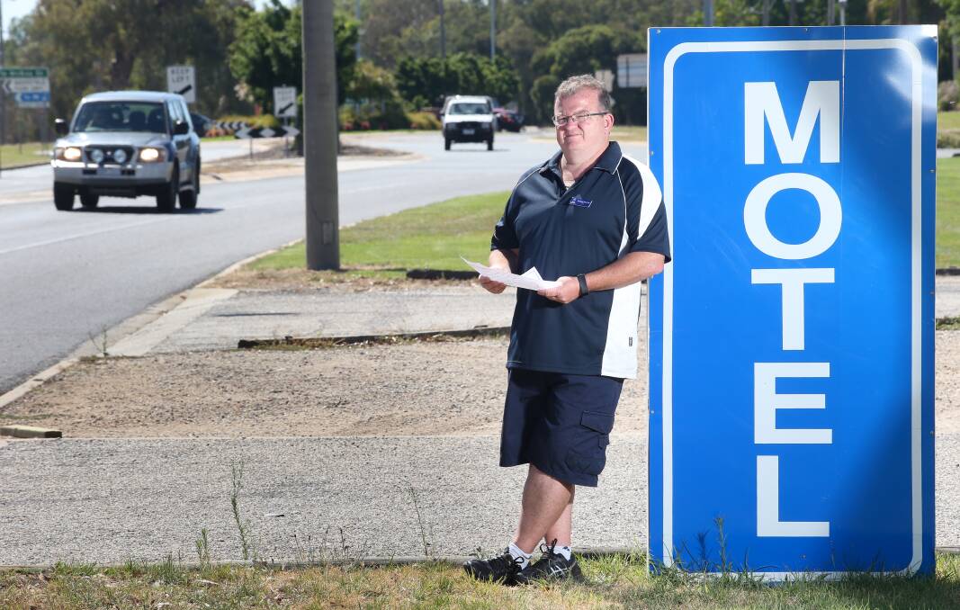 Roadblock to trade: Russell Mackie outside his motel in Melbourne Road with the Hume Freeway exit in the background. Picture: KYLIE ESLER