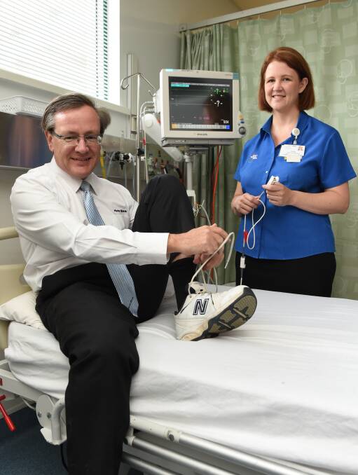 Lacing up: Hume Bank boss David Marshall prepares for the City2City Run Walk with Albury hospital nurse unit manager Rachel Langheim. Picture: MARK JESSER