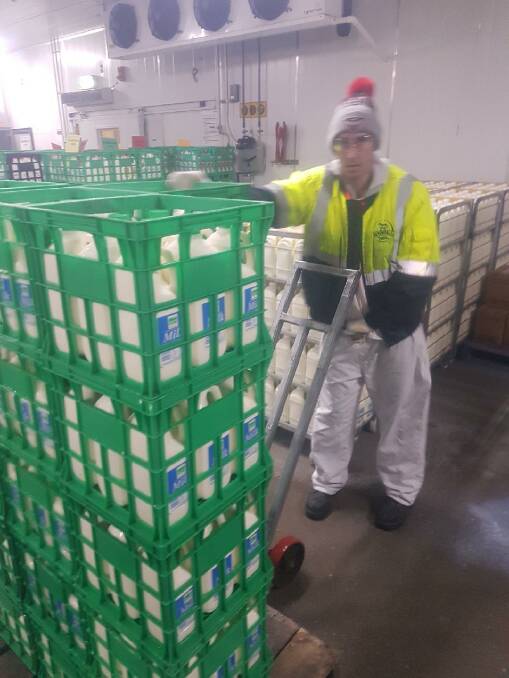 Murray Goulburn worker Doug Austin with some of the last crates of Kiewa Country milk bottled at Kiewa on Thursday night.