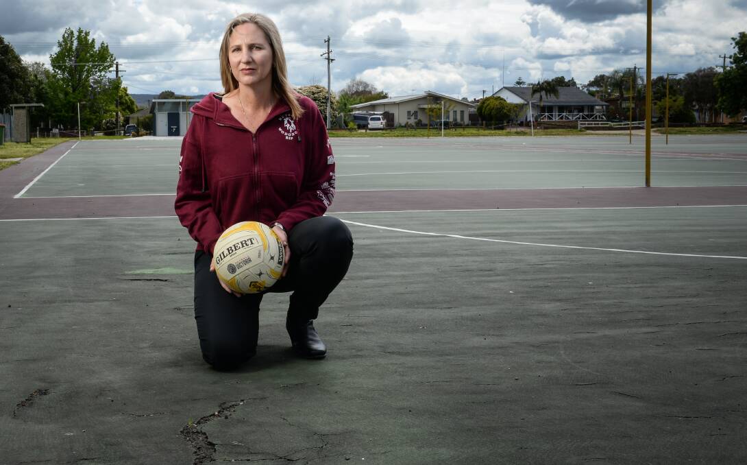 Unplayable: Wodonga Netball Association's Katrina Donelan with a court out of use because of cracks caused by tree roots. Picture: MARK JESSER 