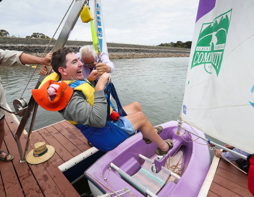 Smoother sailing: Curt Gouma, who has cerebral palsy and needs a wheelchair for mobility, is winched into his boat at the newly built jetty at the Albury-Wodonga Yacht Club on Lake Hume on Saturday. Picture: MARK JESSER 