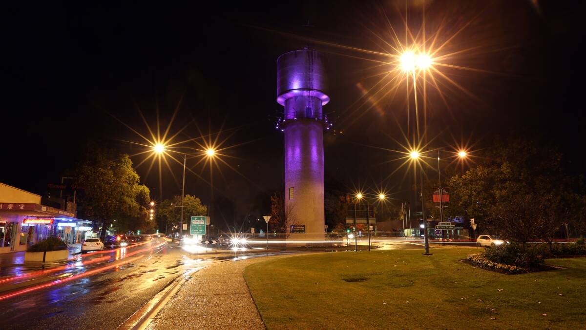 Night light: Wodonga's imposing water tower illuminated after dark.