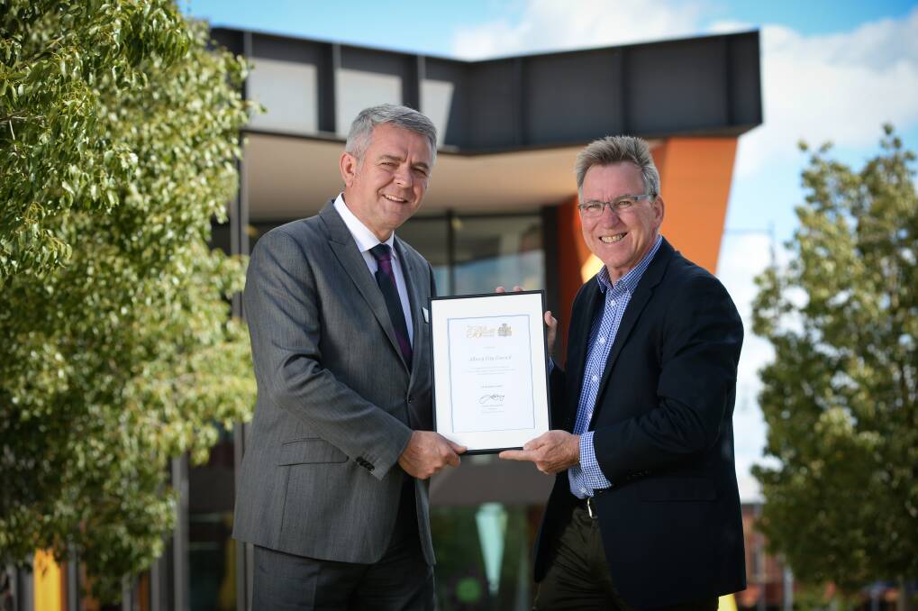 State beaters: Albury Council chief executive Frank Zaknich and mayor Kevin Mack with a certificate recognising the city's Bluett Award. A bronze plaque marking the honour will also be presented in the future to the organisation. Picture: MARK JESSER