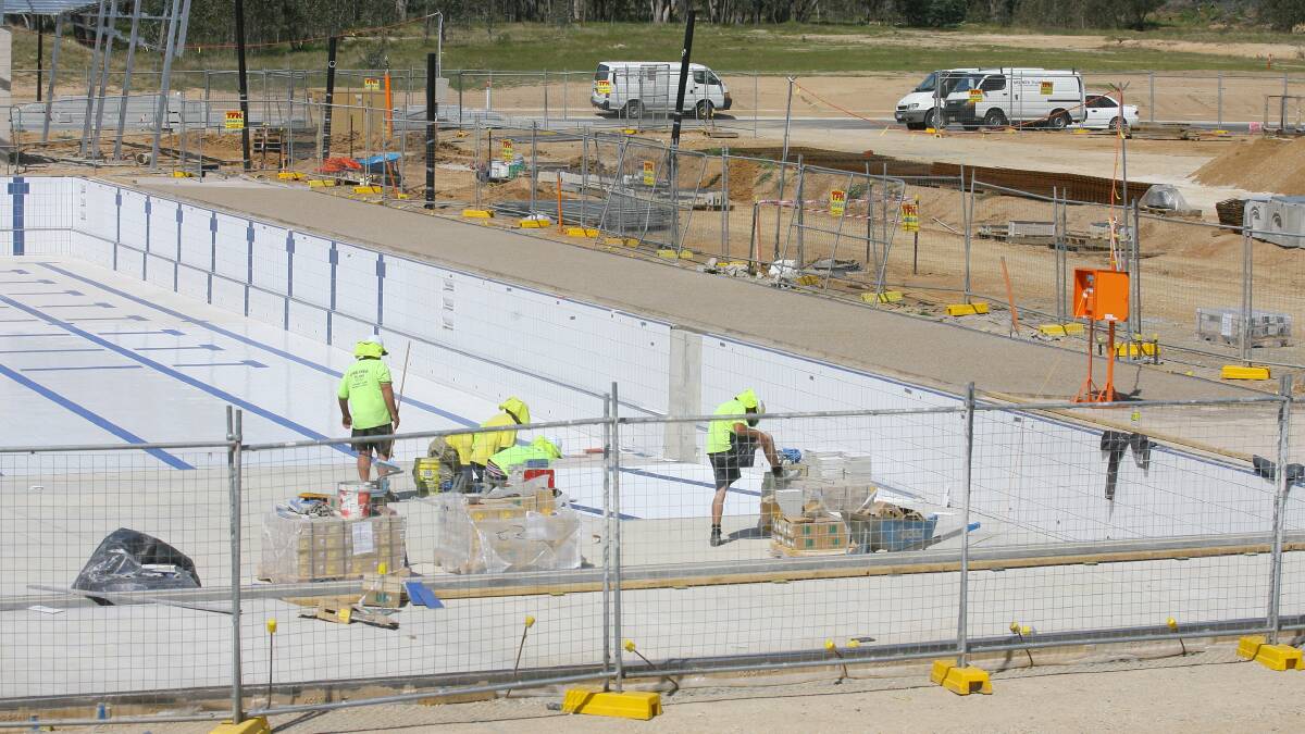 Flashback: Tiling being done on the bottom of the WAVES Olympic pool in October 2012, ahead of its opening five months later.