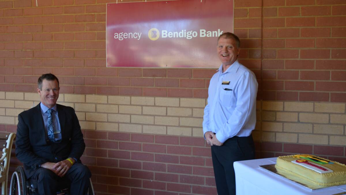 Accounts open: Berrigan mayor Matt Hannan and Bendigo Bank NSW-ACT regional manager Tim Butt with the new sign and celebratory cake following the agency's offical start on Monday. Picture: SOUTHERN RIVERINA NEWS 