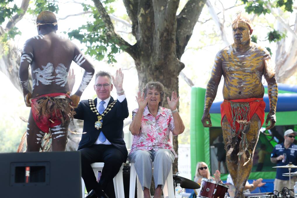 Gratitude: Albury mayor Kevin Mack and Wiradjuri elder Nancy Rooke raise their arms to give the Auslan clap as Three Deadly Rivers end their routine. Picture: KYLIE ESLER