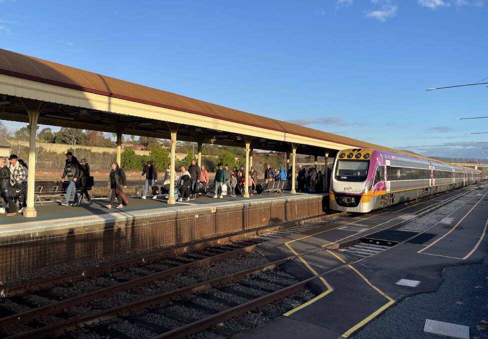 Some of the tens of thousands of people who have travelled on the North East line since the introduction of cheap fares exit a train service at Albury railway station. Picture by Ted Howes 