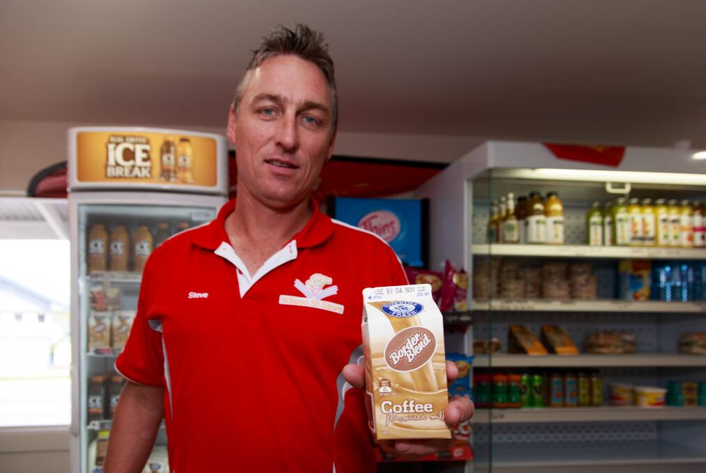 New variety: Wodonga's Wilson Street milk bar operator Steve McLennan with the Border Blend-stickered iced coffee which hit his shelves on Friday. Picture: SIMON BAYLISS