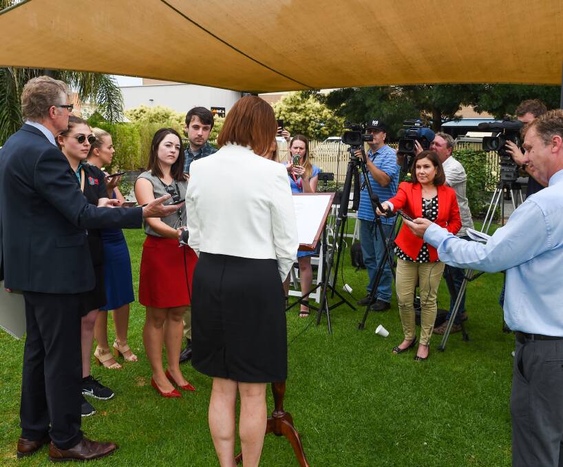 In the glare: Sussan Ley answers questions from the Border's media in the palm-fringed courtyard of the Albury Club on Monday morning. She explained her behaviour around buying a Gold Coast unit. Picture: MARK JESSER