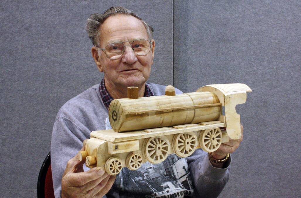 Track work: Club member Keith Smead, of Springdale Heights, and his wooden train going on show at Lavington's Mirambeena centre on Saturday. 