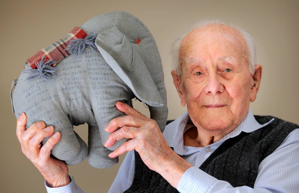 Special item: Ron Clarkson with the elephant mascot Dumbo which was signed by his air force colleagues. The symbol of defiance sat at Mr Clarkson's funeral earlier this month after he died aged 98. Picture: KYLIE ESLER