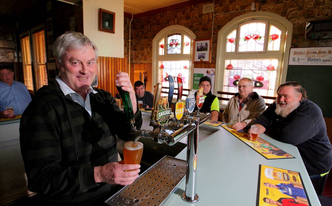 Last drinks: Paddy Hodgkin behind the bar at Henty's Doodle Cooma Arms Hotel which he will shut for the last time on November 7.