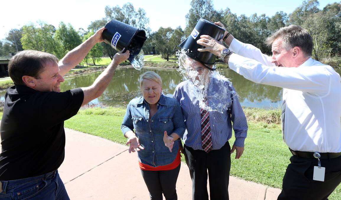 Chill factor: Sandra Moon and fellow 2AY presenter Mark Taylor are doused in freezing water by Border mayors Rodney Wangman and Kevin Mack in the ice bucket challenge in 2014.