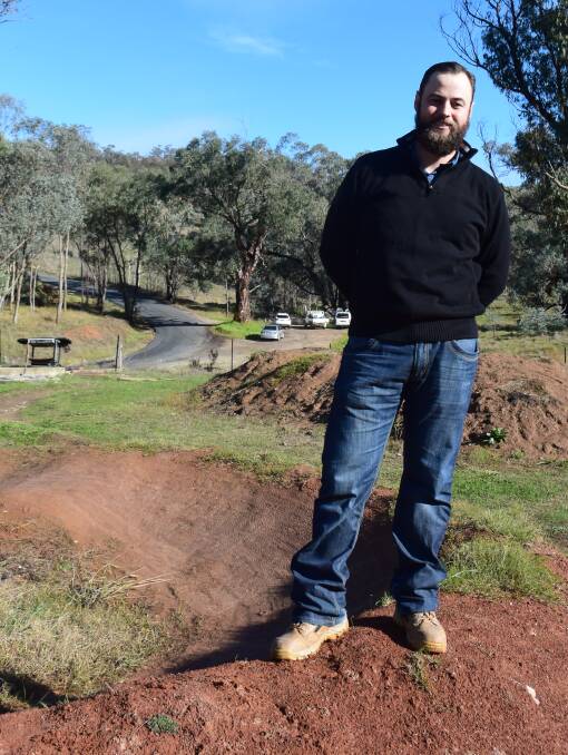 Looking for help: Mountain bike group president Michael Ross at the Felltimber Creek pump track with the car park earmarked for an upgrade in the background.