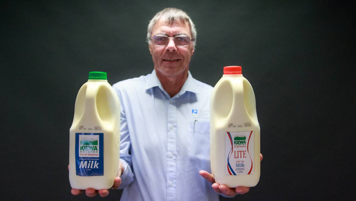 It's back: Wayne Mulcahy with the revamped Kiewa full cream and light milk in their two-litre bottles with front-on handles. Picture: SIMON BAYLISS