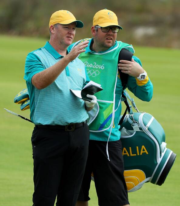 On the road again: Marcus Fraser with caddy Jason Wallis during his record round at the Olympics. Pictures: GETTY IMAGES