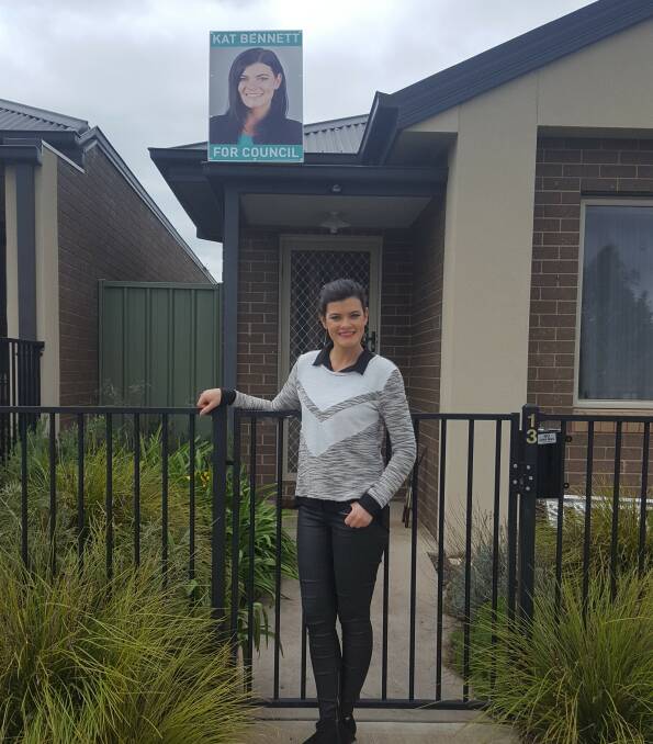 Out of harm's way: Wodonga Council candidate Kat Bennett has placed her last remaining campaign poster on top of her home to deter vandals.